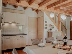 a kitchen and dining room with a table and chairs at Le Lac Bleu nr 33 in Lacapelle-Marival