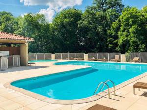 a large swimming pool with blue water at Le Lac Bleu nr 33 in Lacapelle-Marival