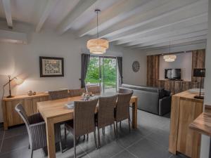 a dining room and living room with a table and chairs at Lac Bleu nr 19 in Lacapelle-Marival