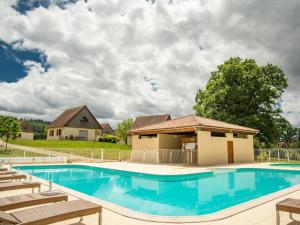 a swimming pool with chairs and a house at Lac Bleu nr 19 in Lacapelle-Marival