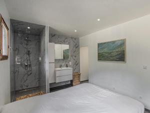 a bedroom with a white bed and a sink at Lac Bleu nr 19 in Lacapelle-Marival +27 photos