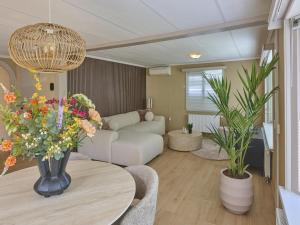 a living room with a couch and a table with flowers at t Kaatsheuveltje 9 in Kaatsheuvel