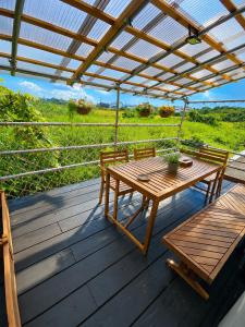 a wooden table and bench on a wooden deck at 湖畔の詩 BBqが楽しめる隠れ家 琵琶湖徒歩5分 in Takashima