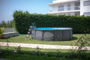a pool with a ladder in a yard at Feel Nazaré - Ocean Villa in Nazaré
