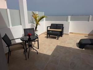 a room with two chairs and a table and a couch at Sweet House 3 in Arrecife