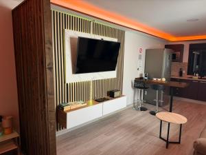 a living room with a flat screen tv on a wall at Sweet House 3 in Arrecife