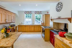 a large kitchen with wooden cabinets and a counter top at 6 Bed in Haslemere oc-c34083 in Haslemere