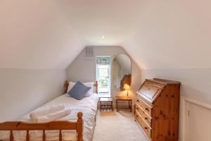 a bedroom with a bed and a dresser in a attic at 6 Bed in Haslemere oc-c34083 in Haslemere +38 photos