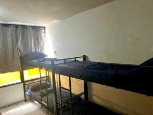 two bunk beds in a room with a window at Hostel Princess Copacabana in Rio de Janeiro