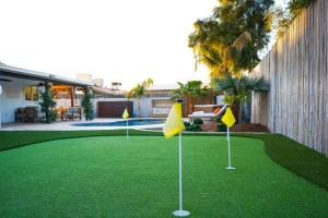 a golf course with yellow flags on the grass at Citrus Grove in Mesa