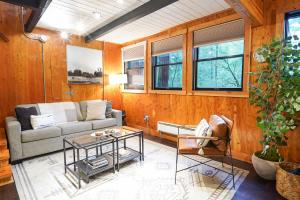 a living room with a couch and a table at Treetop Hideaway, Sleeps 2 in Glacier +63 photos