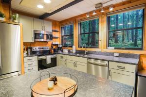 a kitchen with a round table in the middle of it at Treetop Hideaway, Sleeps 2 in Glacier