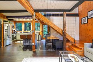 a kitchen and living room with a staircase in a house at Treetop Hideaway, Sleeps 2 in Glacier