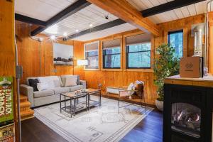 a living room with a couch and a fireplace at Treetop Hideaway, Sleeps 2 in Glacier