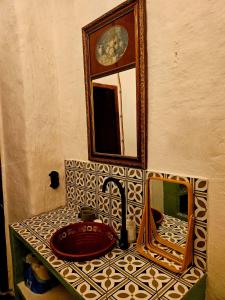 a bathroom with a sink and a mirror on a counter at Casa Buena Vista in Ugíjar +31 photos
