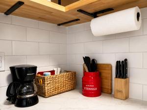 a kitchen counter with a coffee maker and a paper towel roll at KC's Corner Motel in East Springfield
