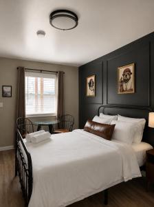 a bedroom with a large white bed and a window at KC's Corner Motel in East Springfield