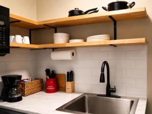 a kitchen counter with a sink and some dishes at KC's Corner Motel in East Springfield +7 photos