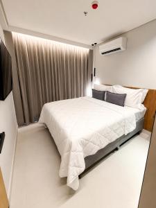 a bedroom with a large white bed in a room at Beach Resort in Salinópolis