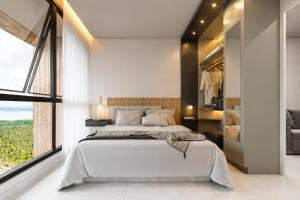 a bedroom with a large bed and a large window at Beach Resort in Salinópolis