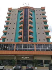 a large building with cars parked in front of it at Hotel Ipoh City in Ipoh