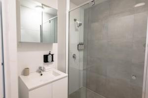 a white bathroom with a sink and a shower at Great Keppel Island Hideaway in Great Keppel +139 photos
