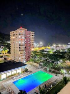 a swimming pool at night in a city at Beach-side condos at Turtle Beach Towers in Ocho Rios
