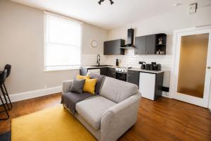 a living room with a couch and a kitchen at City Centre 1 Bed Apartment - Modern & Bright in Chester +6 photos