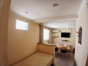 a small room with a table and a dining room at Hualcupén Alfa in Copahue