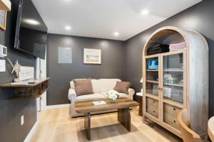 a living room with a couch and a table at Coral Cottage - Tiny Home at Hampton Beach in Hampton +17 photos
