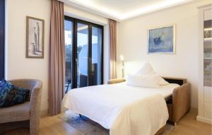 a hotel room with a bed and a chair at Princess in Binz +31 photos
