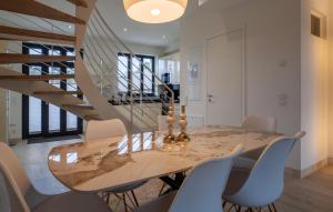 a dining room with a marble table and chairs at Diamond in Binz