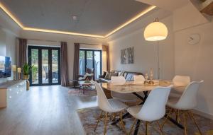 a dining room and living room with a table and chairs at Diamond in Binz