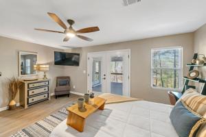 a living room with a ceiling fan and a couch at Lakeside Lodge on Bluegill- Arcade, Dock, FirePit in Eatonton