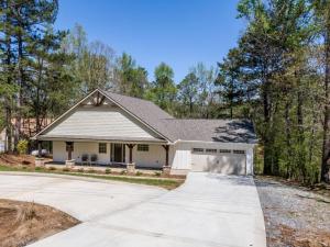 a large white house with a driveway at Lakeside Lodge on Bluegill- Arcade, Dock, FirePit in Eatonton