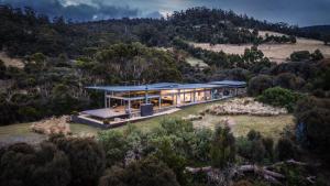 a house on top of a hill with trees at Avalon Coastal Retreat in Swansea