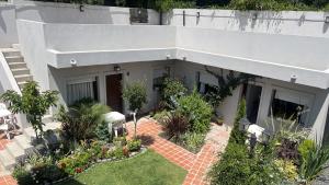 a house with a garden in front of it at Espacio493 in Villa Gesell
