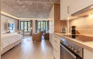a kitchen and a bedroom with a bed and a table at Baltic in Binz