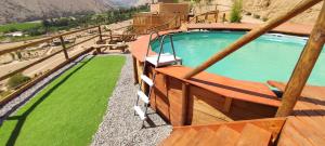 an overhead view of a swimming pool with green grass at Cabañas "Terrazas de Orión" con Vista Panorámica en Pisco Elqui in Pisco Elqui