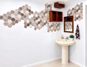 a bathroom with a sink and a mirror at The Beloved Corner in Nausori +16 photos