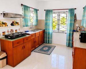 a kitchen with wooden cabinets and a sink at The Beloved Corner in Nausori