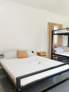 a bed in a room with a white mattress at Veronica Palms in Pooc +25 photos