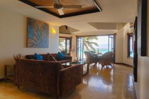 a living room with a couch and a table at Reflections On Rarotonga in Rarotonga