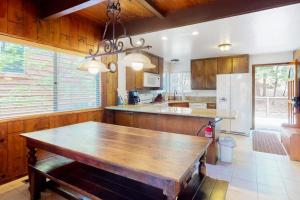 a kitchen with a large wooden table in it at Rocky Pines in Twin Peaks
