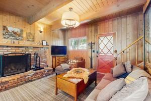a living room with a couch and a fireplace at Wooded Comfort in Lake Arrowhead