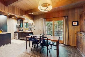 a dining room with a table and chairs in a kitchen at Wooded Comfort in Lake Arrowhead