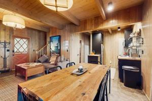 a living room with a large wooden table and a couch at Wooded Comfort in Lake Arrowhead