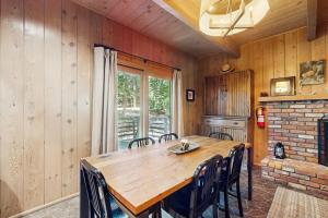 a dining room with a wooden table and chairs at Wooded Comfort in Lake Arrowhead