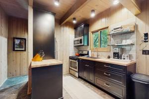 a large kitchen with wooden walls and wooden counters at Wooded Comfort in Lake Arrowhead +14 photos