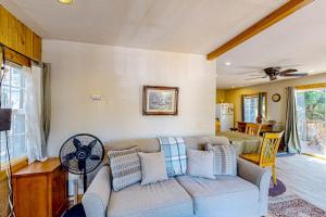 a living room with a couch and a fan at Heliotrope Hideaway in Lake Arrowhead